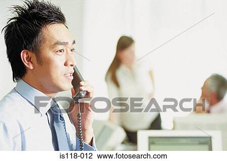 Businessman on telephone in office View Large Photo Image Stock Image - Businessman on telephone in office. Fotosearch