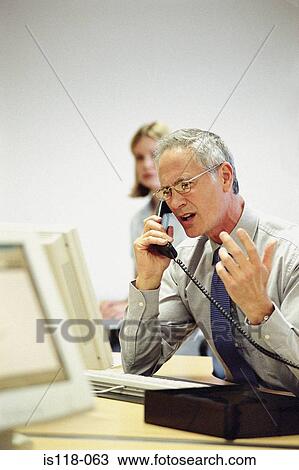 Businessman on telephone in office View Large Photo Image Stock Image - Businessman on telephone in office. Fotosearch
