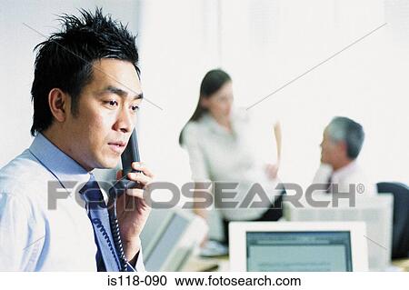 Stock Image - Businessman on telephone in office. Fotosearch