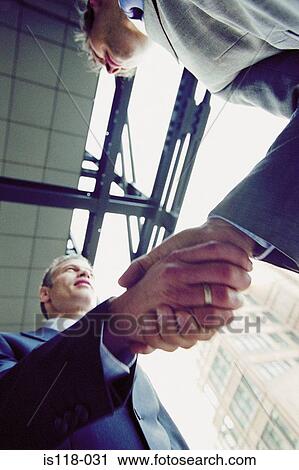 Stock Image - Businessmen shaking hands. Fotosearch