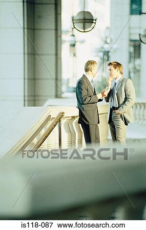 Businessmen talking outside office View Large Photo Image Stock Photo - Businessmen talking outside office. Fotosearch