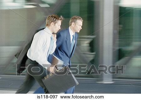 Businessmen walking briskly View Large Photo Image Stock Photo - Businessmen walking briskly. Fotosearch