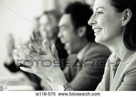 Stock Photography - Businesspeople applauding in meeting. Fotosearch