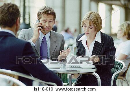 Stock Image - Businesspeople having meeting at cafe. Fotosearch