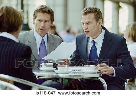 Stock Photo - Businesspeople having meeting at cafe. Fotosearch