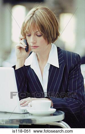 Businesswoman with laptop and cellphone at a cafe View Large Photo Image Stock Image - Businesswoman with laptop and cellphone at a cafe. Fotosearch