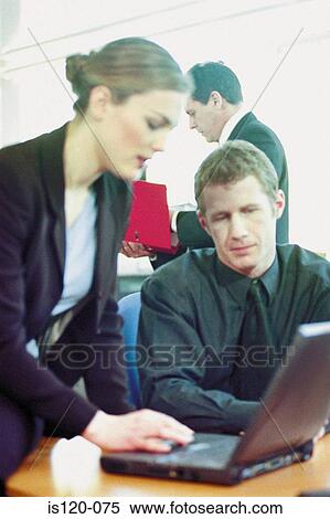 Businessman and businesswoman using laptop in office View Large Photo Image Stock Photography - Businessman and businesswoman using laptop in office. Fotosearch