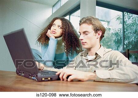 Man and woman at home with laptop View Large Photo Image Stock Photo - Man and woman at home with laptop. Fotosearch