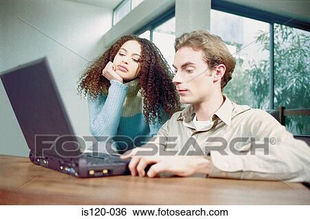 Man and woman at home with laptop View Large Photo Image Stock Photograph - Man and woman at home with laptop. Fotosearch