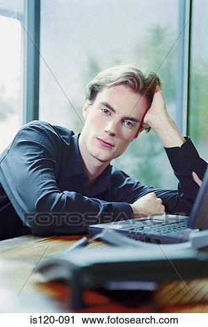 Stock Image - Man on laptop at home. Fotosearch