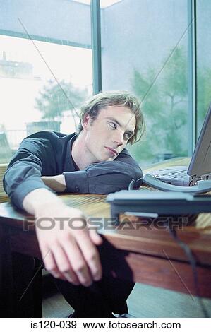 Man on laptop at home View Large Photo Image Stock Photo - Man on laptop at home. Fotosearch