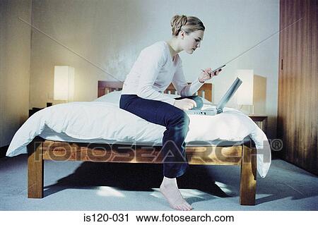 Woman in bedroom with laptop View Large Photo Image Stock Image - Woman in bedroom with laptop. Fotosearch