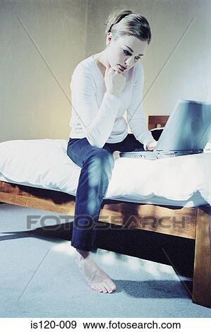 Woman in bedroom with laptop View Large Photo Image Stock Photo - Woman in bedroom with laptop. Fotosearch