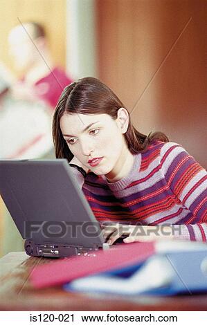 Stock Image - Woman on laptop at home. Fotosearch