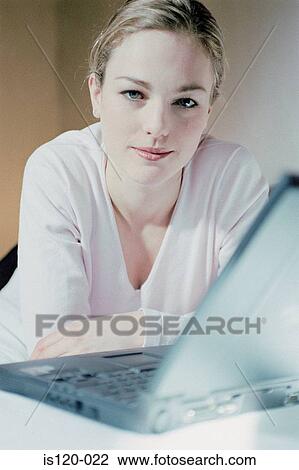 Woman on laptop at home View Large Photo Image Stock Image - Woman on laptop at home. Fotosearch