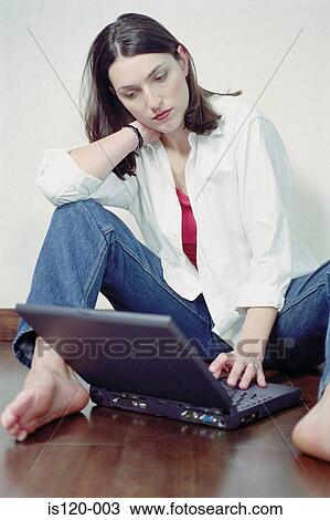 Woman with laptop sitting on floor View Large Photo Image Stock Image - Woman with laptop sitting on floor. Fotosearch