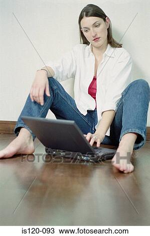 Woman with laptop sitting on floor View Large Photo Image Stock Image - Woman with laptop sitting on floor. Fotosearch