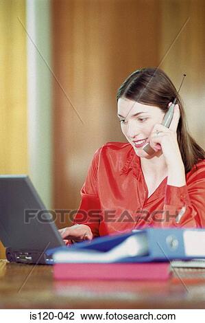 Stock Image - Woman working at home. Fotosearch
