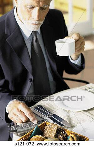 Businessman having breakfast with cellphone View Large Photo Image Stock Image - Businessman having breakfast with cellphone. Fotosearch