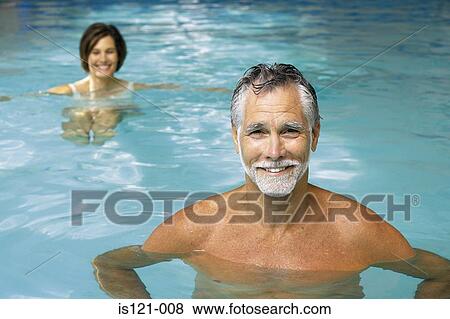 Man and woman in swimming pool View Large Photo Image Stock Photo - Man and woman in swimming pool. Fotosearch