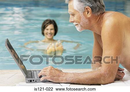 Man and woman in swimming pool with computer View Large Photo Image Stock Image - Man and woman in swimming pool with computer. Fotosearch