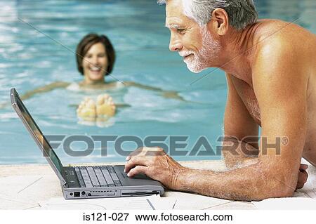 Man and woman in swimming pool with computer View Large Photo Image Stock Photo - Man and woman in swimming pool with computer. Fotosearch