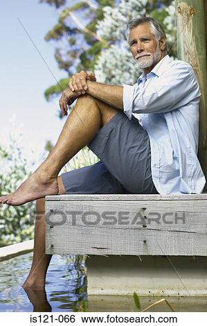 Man beside pool View Large Photo Image Stock Photograph - Man beside pool . Fotosearch
