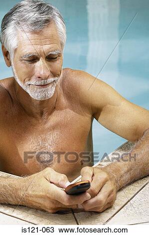 Man in swimming pool with cellphone View Large Photo Image Stock Image - Man in swimming pool with cellphone. Fotosearch