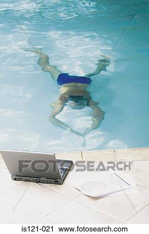 Man in swimming pool with computer View Large Photo Image Stock Image - Man in swimming pool with computer. Fotosearch