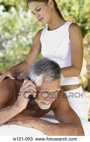 Man with cellphone being massaged View Large Photo Image Stock Image - Man with cellphone being massaged. Fotosearch