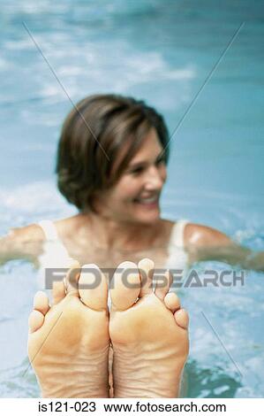 Stock Image - Woman in swimming pool. Fotosearch