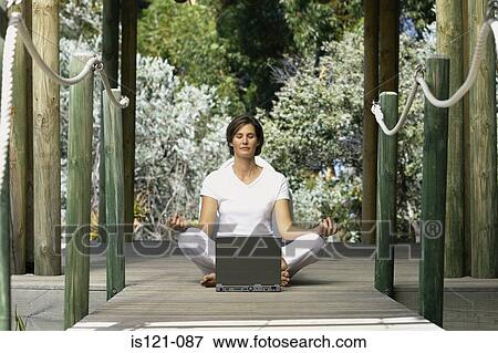 Woman with computer doing yoga View Large Photo Image Stock Photo - Woman with computer doing yoga. Fotosearch