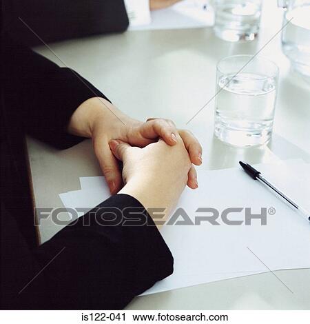 A female executive with her fingers interlocked at a meeting View Large Photo Image Stock Image - A female executive with her fingers interlocked at a meeting. Fotosearch