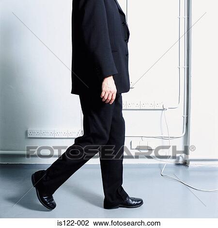 A Man walking past wall plugs View Large Photo Image Stock Image - A Man walking past wall plugs . Fotosearch