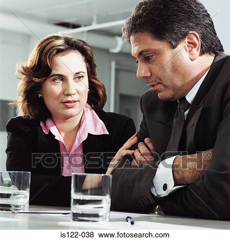 Stock Photo - Advising a colleague over a difficult situation. Fotosearch