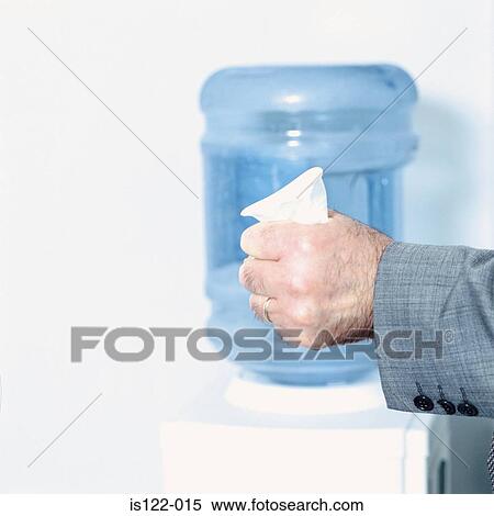 Stock Photography - An angry Man squashing a paper cup . Fotosearch