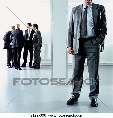 Men and a woman talking at an open plan office View Large Photo Image Stock Photograph - Men and a woman talking at an open plan office . Fotosearch