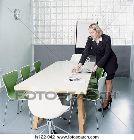 Secretary preparing the meeting room View Large Photo Image Stock Image - Secretary preparing the meeting room . Fotosearch
