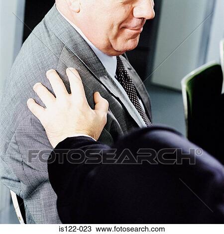 Stock Image - Two men supporting each other. Fotosearch
