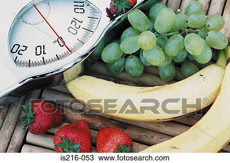 Stock Image - Fruit and scales. Fotosearch