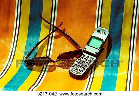 Deckchair, sunglasses and mobile phone View Large Photo Image Stock Image - Deckchair, sunglasses and mobile phone. Fotosearch