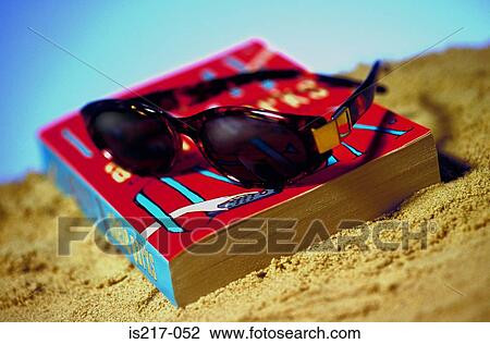 Stock Image - Sunglasses and book. Fotosearch