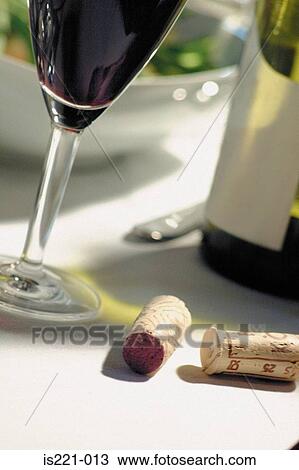 Glass and bottle of red wine on table View Large Photo Image Stock Image - Glass and bottle of red wine on table. Fotosearch