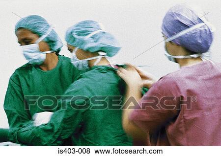 Surgeons dressing for operation View Large Photo Image Stock Photo - Surgeons dressing for operation. Fotosearch