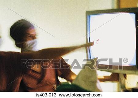 Stock Image - Surgeons in front of monitor. Fotosearch