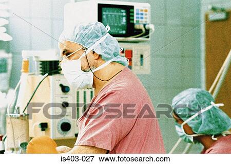 Surgeons in operating theatre View Large Photo Image Stock Photo - Surgeons in operating theatre. Fotosearch