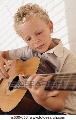 Boy playing guitar View Large Photo Image Stock Photograph - Boy playing guitar. Fotosearch