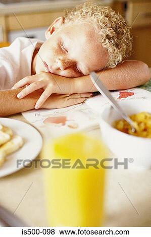 Boy sleeping at breakfast View Large Photo Image Stock Photo - Boy sleeping at breakfast. Fotosearch