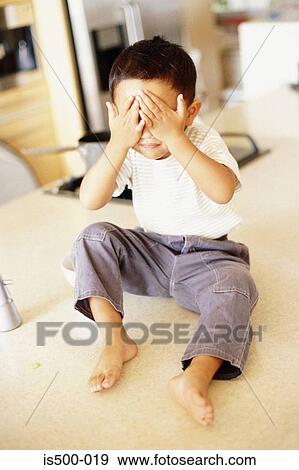 Boy with hands over eyes View Large Photo Image Stock Photo - Boy with hands over eyes. Fotosearch