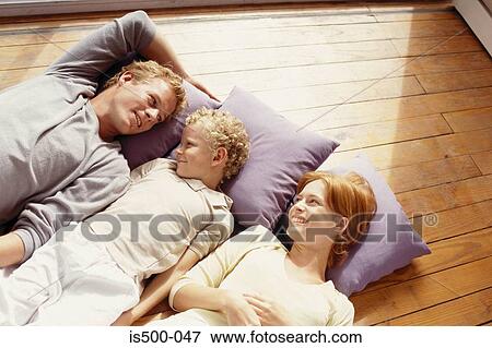 Family lying on floor View Large Photo Image Stock Photo - Family lying on floor. Fotosearch
